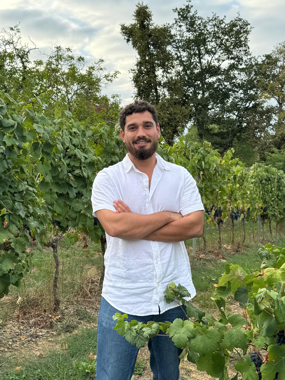 Callen Everitt, Director of Wilderness Wines, standing in a vineyard at sunset